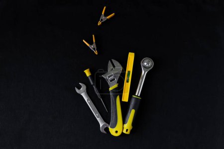 Photo for Maintenance, construction tools on black, dark background. - Royalty Free Image