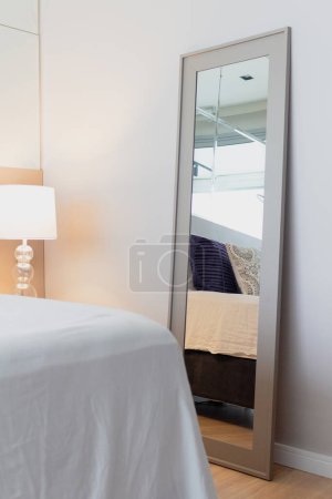 Photo for Bed reflection in the mirror. Modern classic design. Comfortable home interior. - Royalty Free Image