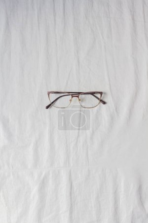 Photo for Top view of glasses on white cotton fabric. - Royalty Free Image