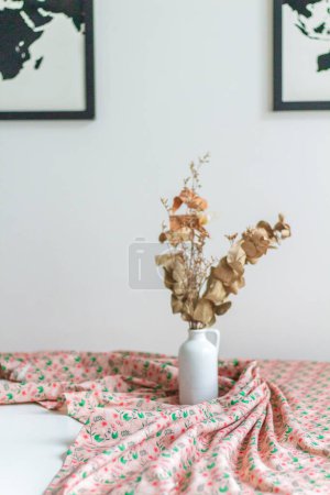 Photo for Closeup view of dried eucalyptus in vase on colorful tablecloth - Royalty Free Image