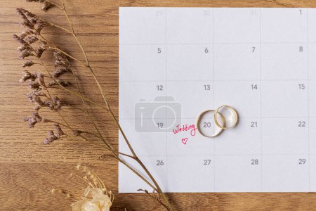 Photo for Wedding Preparations Flat Lay - Bridal Planner and Golden Wedding Rings - Royalty Free Image