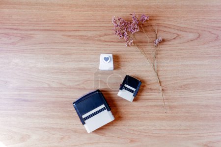 Téléchargez les photos : Timbres et coupe-papier coeur avec fleurs lilas sur fond bois. - en image libre de droit