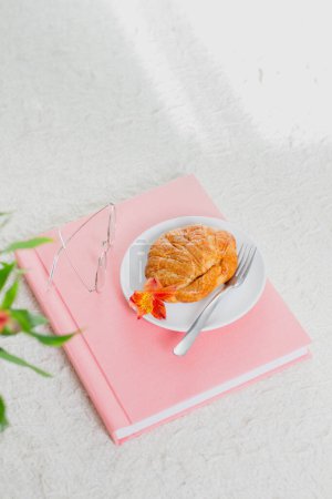 Photo for Croissant on pink wedding or family photo album. White background. Overhead view. Spring, romantic composition . - Royalty Free Image