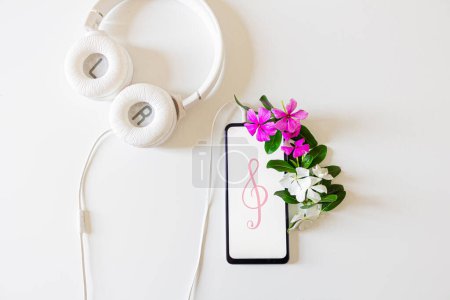 Photo for Home office desk mockup with smartphone, headphone and flowers on white background. - Royalty Free Image