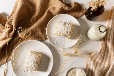 Photo for Top view of breakfast beige cozy composition with coconut cake. - Royalty Free Image