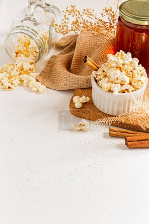 Photo for Cozy and aesthetic brown composition with popcorn on white background. Autumn, winter food concept. - Royalty Free Image
