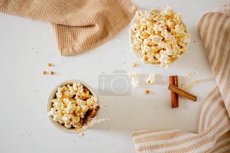 Photo for Cozy composition of popcorn in bowls with cinnamon sticks. Autumn, winter food concept. - Royalty Free Image