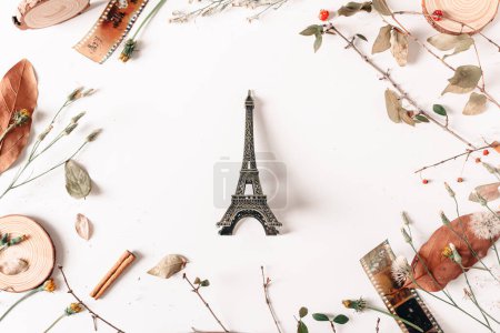 Photo for Frame with dry autumn leaves, vintage camera films, wood pieces, cinnamon, berries and eiffel tower on white background. Fall, autumn concept. Mock up, flat lay. - Royalty Free Image