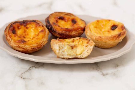 Photo for Nata Pastel. Food styling. Aesthetic composition.  Portuguese egg tarts on white plate - Royalty Free Image