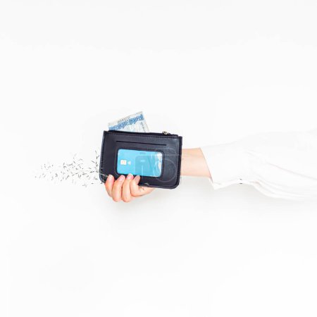 Photo for Female hand holding a wallet on white background. Aesthetic concept. - Royalty Free Image