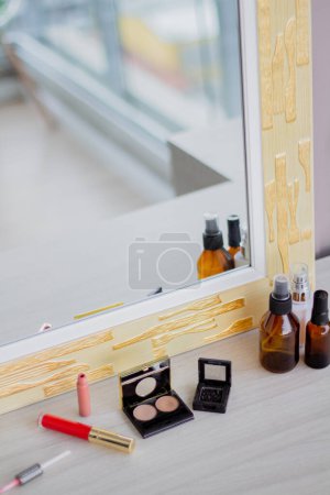 Photo for Cropped shot of mirror with cosmetic set. Makeup composition. Modern classic design. Comfortable home interior. - Royalty Free Image