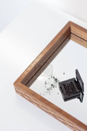 Photo for Beautiful black eye shadow palette on mirror tray - Royalty Free Image