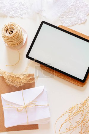 Photo for Top view of digital tablet with envelopes and dried flowers - Royalty Free Image