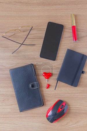 Photo for Flat lay feminine accessories collage with notepad, heart shape audio divider, glasses, mouse and red lipstick on a wooden background. - Royalty Free Image