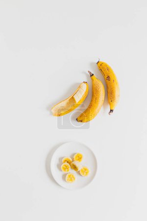 Photo for Sliced ripe banana on white plate - Royalty Free Image