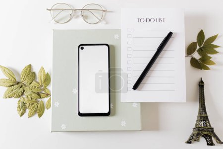Photo for Flat lay of to do list with copy space. Home office desk workspace decorated with Eiffel Tower, dried plants and stationery. - Royalty Free Image