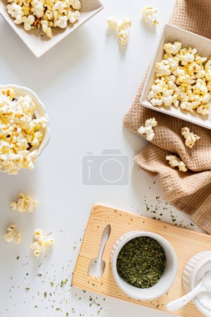 Photo for Top view of aesthetic beige composition with popcorn in kitchenware. Autumn, winter food concept. - Royalty Free Image