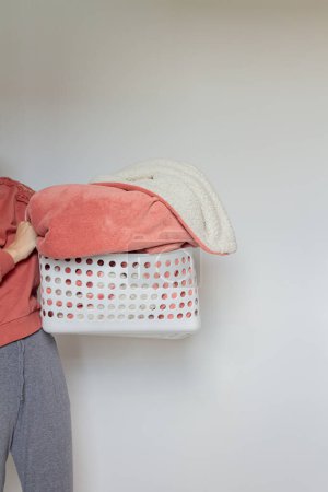 Photo for Young woman holding a basket with a blanket inside - Royalty Free Image