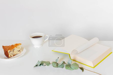 Photo for Breakfast composition with coffee, book, piece of cake on white background.  Slow morning routine concept. - Royalty Free Image