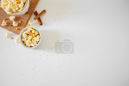 Photo for Cozy composition of popcorn in bowls with cinnamon sticks. Autumn, winter food concept. - Royalty Free Image