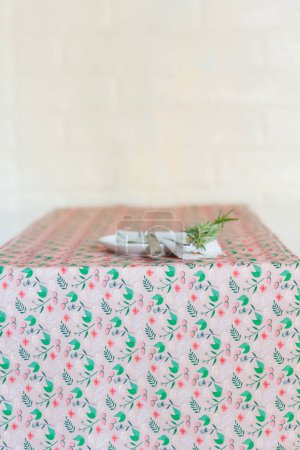 Photo for White plate decorated with fresh stem on colorful tablecloth - Royalty Free Image