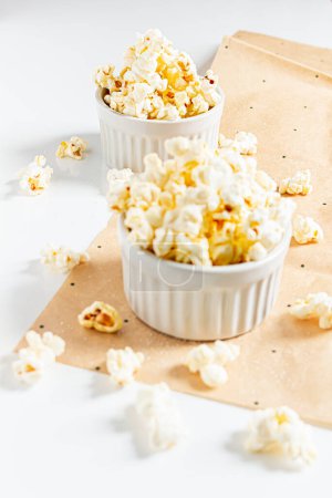 Photo for Aesthetic composition with popcorn in white bowls on white background. Autumn, winter food concept. - Royalty Free Image