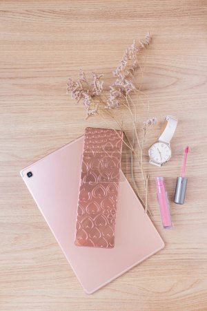 Photo for Beauty blog fashion concept. Female styled accessories: rose gold tablet, wrist watch, wildflowers and cosmetics on wooden background. Flat lay, top view trendy feminine background. - Royalty Free Image