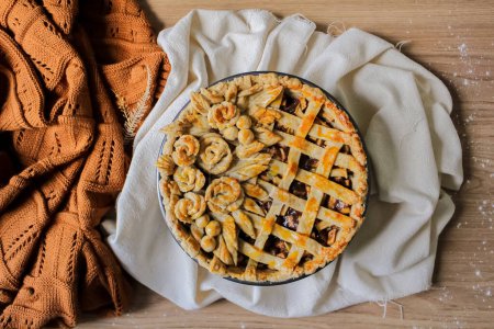 Photo for Decorated apple pie on a table. Autumn composition. Cozy concept. Blog, blogger and social media. - Royalty Free Image