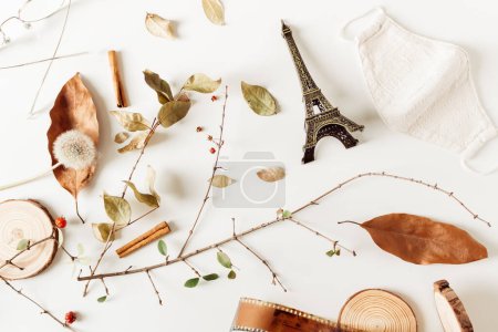 Photo for Dry autumn leaves, vintage camera films, wood pieces, cinnamon, berries, eiffel tower and mask on white background. Fall, autumn concept. Mock up, flat lay. - Royalty Free Image