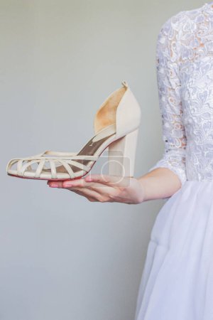 Foto de Joven y bonita novia sosteniendo zapato - Imagen libre de derechos