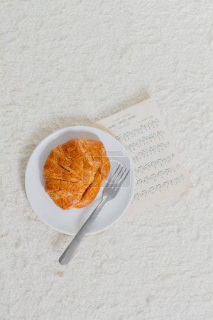 Photo for Morning breakfast with croissant. Musician routine concept. - Royalty Free Image