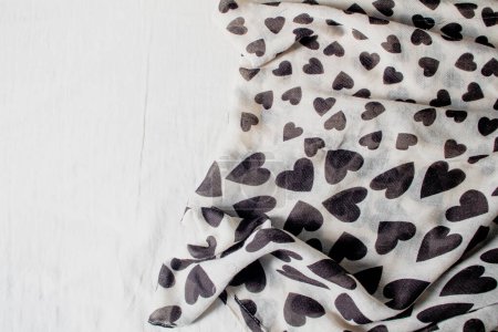 Photo for Black and white scarf with heart shaped pattern on white background. - Royalty Free Image
