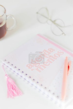 Photo for Feminine composition with notebook, pen, glasses and cup of tea on white background. - Royalty Free Image