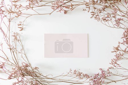 Foto de Marco floral hecho de flores lila y sobre de papel en blanco en el centro. - Imagen libre de derechos