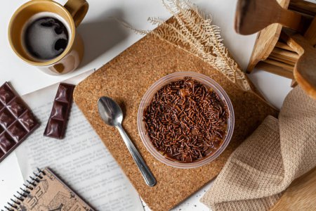 Photo for Carrot and chocolate jar cake vintage composition with cork, notebook, book page, coffee mug, kitchen cloth, chocolate bar and wooden kitchen utensils. Food concept. - Royalty Free Image