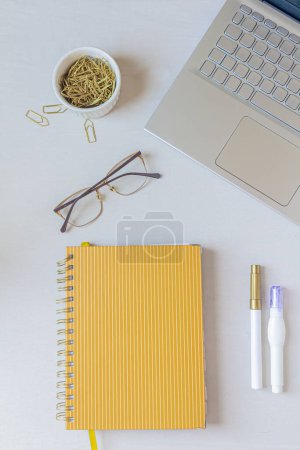Photo for Modern office desk workspace with laptop, notebook and stationery supplies on white background. - Royalty Free Image