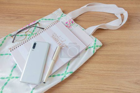 Photo for Neutral fashion composition with cotton bag, notebook, glasses and smartphone . Minimal lifestyle concept. - Royalty Free Image