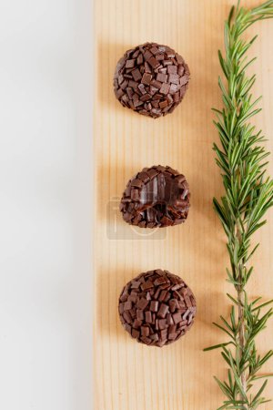 Photo for Top view of traditional brazilian brigadeiro candies on pine woods. Aesthetic composition. Food Styling. - Royalty Free Image