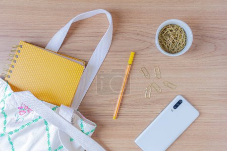 Photo for Workspace with notebook, smartphone and stationery items on wooden background. Flat lay, top view - Royalty Free Image