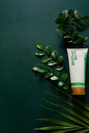Photo for Vegan cosmetic cream with green leaves isolated on deep green background. Skin care concept. - Royalty Free Image