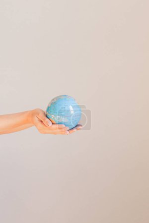 Photo for Young woman's hand holding the earth - Royalty Free Image