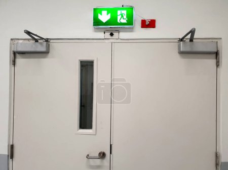 Photo for Manual door closer for exit way: A manual door closer stores the energy used in the opening of the door in a compression or torsion spring and releases it to close the door. - Royalty Free Image
