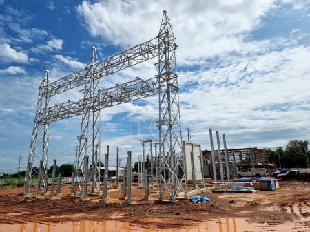 Photo for Construction of Substation: Steel structure of high voltage take-off tower in the switchyard, Power transformer foundation, and control building - Royalty Free Image