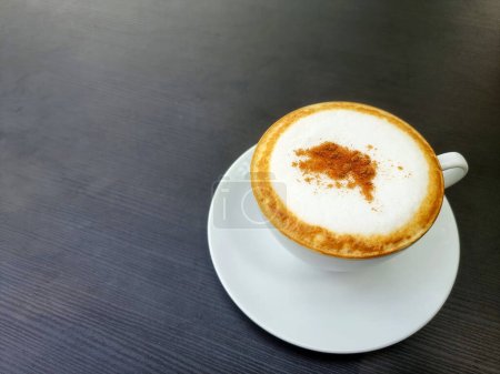 Photo for A cup of hot cappuccino coffee is on the table. - Royalty Free Image