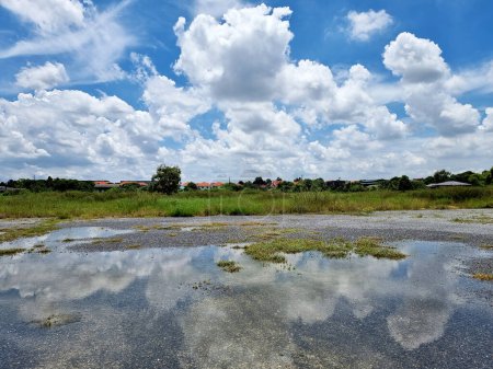 Photo for The perspective of clouds in the blue sky reflected in the water on the ground - Royalty Free Image