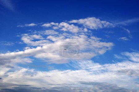 Photo for The Airplane flying over the clouds in the blue sky backgrounds - Royalty Free Image