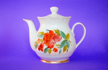White ceramic teapot, teapot with handle and lid on colored background. For preparing drinks such as tea, coffee, cocoa, water, soup. Dishes for home, kitchen, comfort. Lonely container