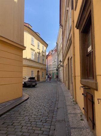 Charming Prague alley with historic architecture and cobblestone streets.