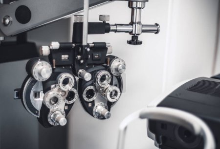 Téléchargez les photos : A capture of a black-colored phoropter, an ophthalmic testing device for checking the eyesight, selective focus on the part of the device with scales and digits in an ophthalmologist's office - en image libre de droit