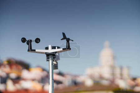 Photo for A sleek black and white wireless weather station is in sharp focus against a dreamy defocused backdrop of Lisbon; The device is designed to provide accurate weather information, an indispensable tool - Royalty Free Image